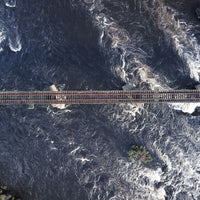 6616ab8ed8c3c268632d0a1d_aerial-view-of-a-train-track-across-a-river-in-tasmania-australia_1768020910890.jpg