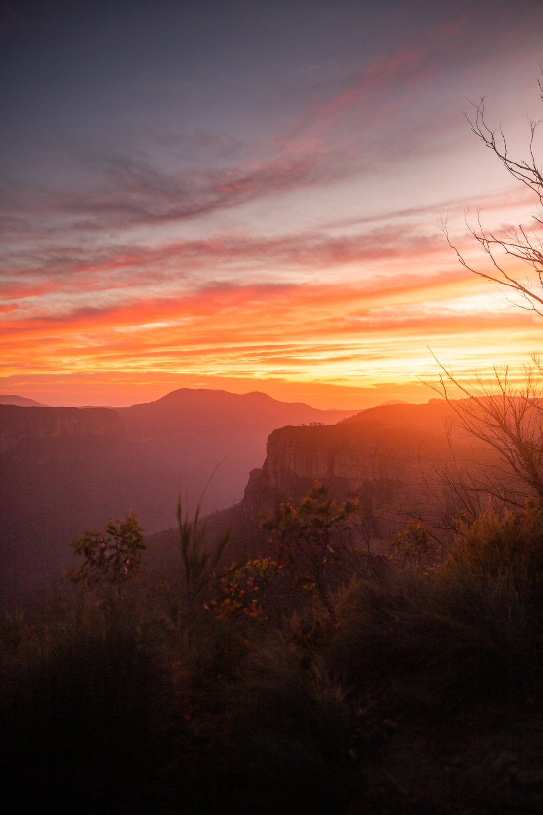 6616ab8ed8c3c268632d0a1d_fire-sky-blue-mountains_1787836689193.jpg