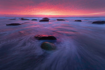 Red sunrise over Turimetta beach