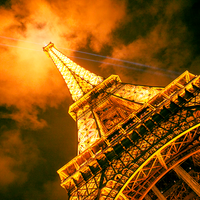 Eiffel Tower with it's beaming lights at night in Paris