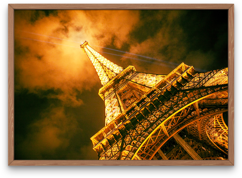 Eiffel Tower with it's beaming lights at night in Paris