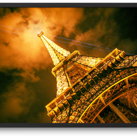 Eiffel Tower with it's beaming lights at night in Paris