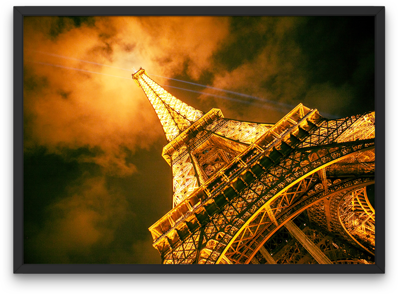 Eiffel Tower with it's beaming lights at night in Paris